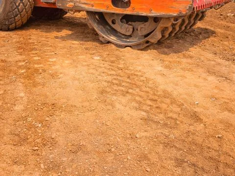 Road structure compacted with Vibratory Padfoot Compactor. Heavy machinery is Stock Photos