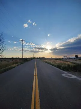 Road with sun setting Stock Photos
