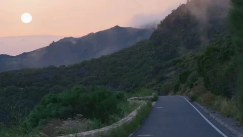 The road to the sunset on a high mountain pass among clouds and strong winds Stock-Footage 100453345