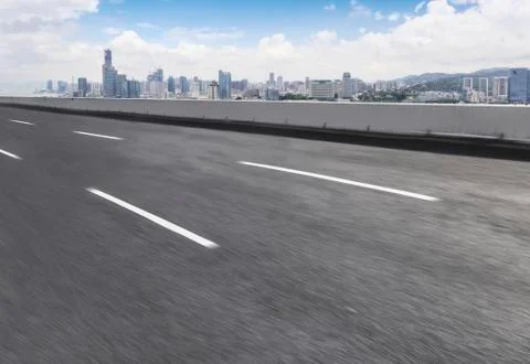 Road surface and city skyline Stock Photos