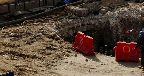 Road surface construction with large earth holes, wires, steel and barrier panel Stock Footage 168569338