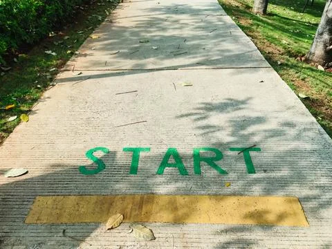 On the road surface it says start as a sign below that is the starting poin.. Stock Photos