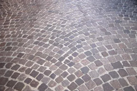 Road surface made of brown rectangular granite stones 스톡 사진