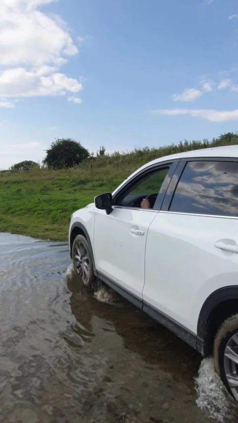 Off road suv car getting out from the river beach Stock Footage 170649071