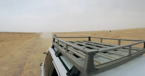 Off-road SUVs driving through the vast Sahara Desert during a desert safari Stock Footage 305238030