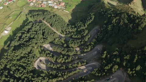 Road with Switchback Going Up Mountain Around Thick Green Forest Aerial Drone Stock Footage 115546718