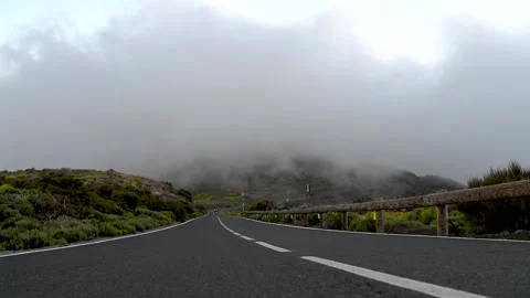 Road at Teide National Park with fast cloud inversion passing close to ground Stock Footage 334975355