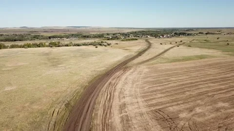 The road through the fields leading to a small village. Video stock 137778342