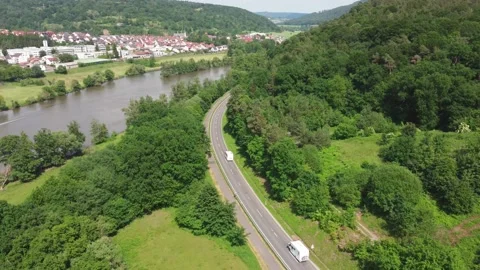 Road through the forest leading to the city Stock Footage 155597199