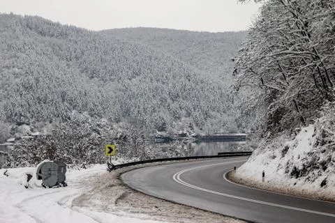 Road through forest with trees covered with snow Stock Photos