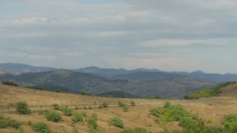 Road through hilly terrain Stock Footage 79449630