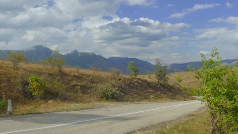 Road through hilly terrain Stock Footage 79451075