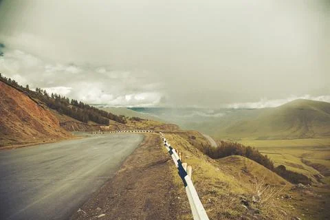 Road through mountains Stock Photos