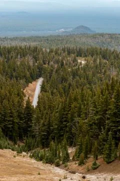 Road through pine forest seen from Crater Lake Stock Photos