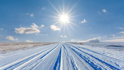 Road through a snowbound winter plain Stock Footage 312781248