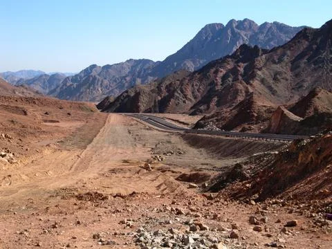Road Track among the desert rocks of the Sinai Mountains. Yellow brown ston.. Stock Photos