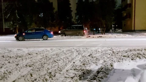 Road traffic accident in winter on a slippery road in the city with cars with Stock Footage 293684644
