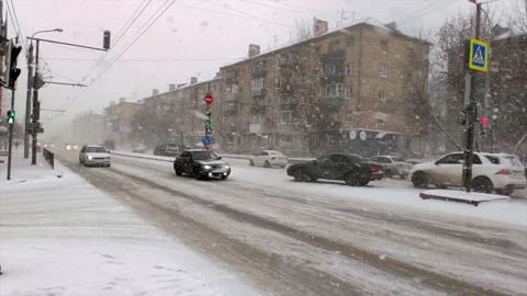 Road traffic and falling snow Stock Footage 221730449