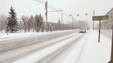 Road traffic and falling snow Stock Footage 221731456
