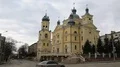 Road traffic near Church of Dormition of Virgin Mary in Ternopil, Ukraine HD Footage