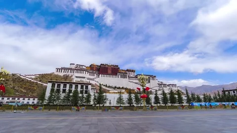 Road traffic passing below Potala Palace under moving clouds Video stock 345883166