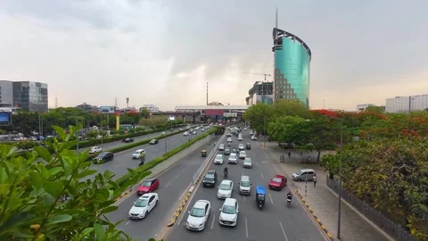 Road traffic on Raghvendra Marg with DLF Gateway Tower building, Gurgaon Stock Footage 314907737