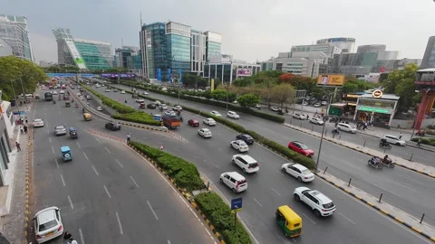 Road traffic on Raghvendra Marg with Infinity Tower A at the background Stock Footage 314675255