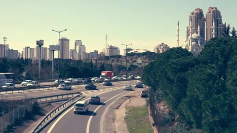 Road traffic in two different ways with modern mosque in the background. Stock Footage 145698455
