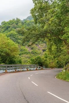A road with a tree on the side Stock-Fotos