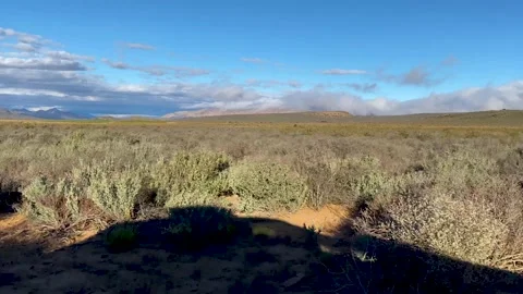 Road trip across a mountain plain on a dirt road, South Africa Stock Footage 181466503