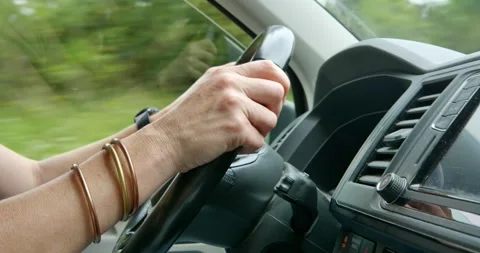 Road Trip: A close-up shot shows a driver's hands gripping Stock Footage 334375557