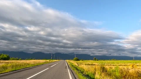 Road trip on an empty road. Clouds moving over empty countryside road Stock Footage 316212695