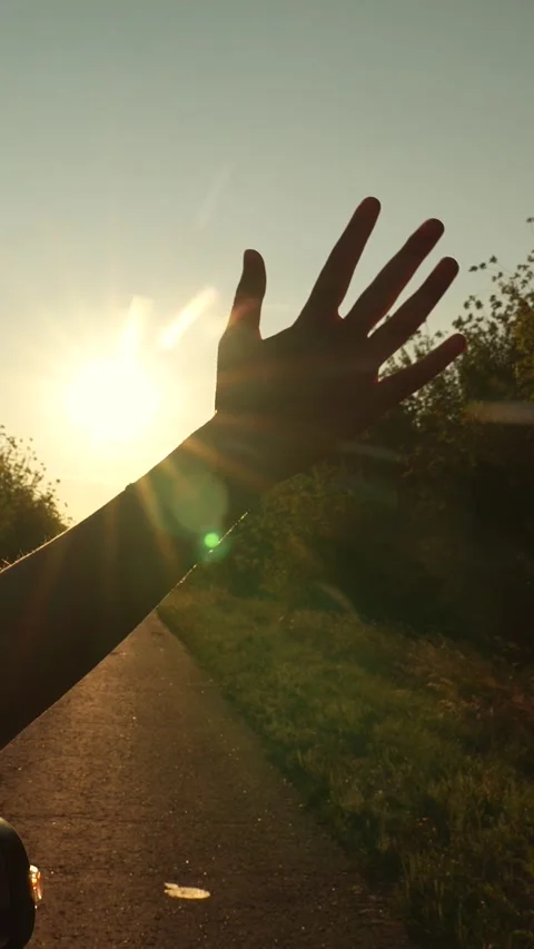Road trip female hand from window of driving car at sunset sunrise rural summer Stock Footage 274039728