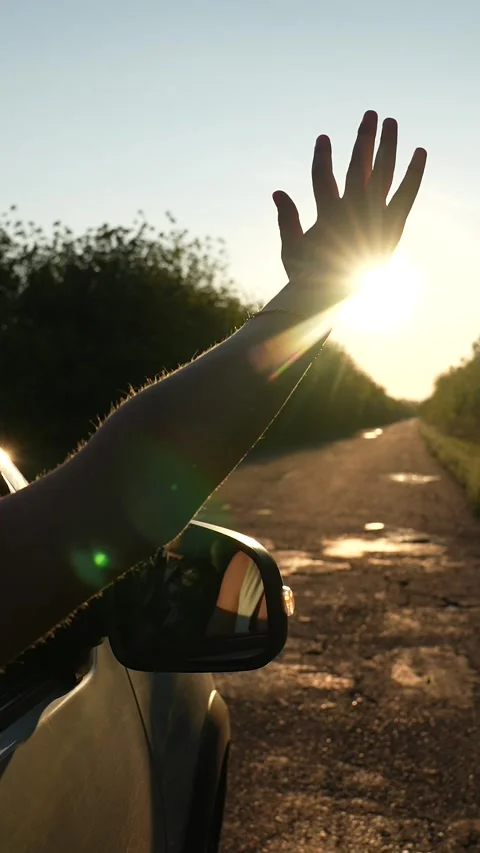 Road trip female hand from window of driving car at sunset sunrise rural summer Stock Footage 294667774