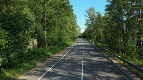 Road Trip into Forest with Tree shadows on the road Stock Footage 140581966