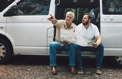 Road trip, map or lost men pointing in travel car, van or moving camper on Stock Photos