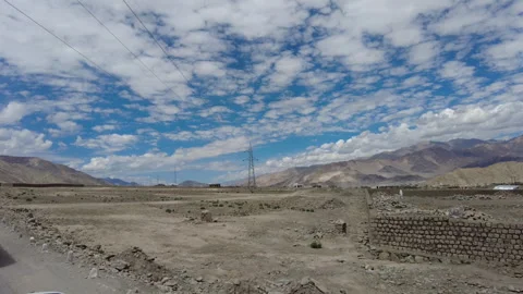 Road trip. Vast plain with Himalayas mountain range at skyline. Stock Footage 262297859