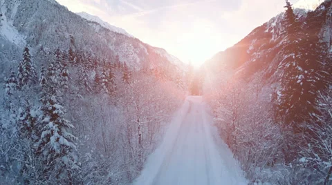 Road trough forest. beautiful winter snow landscape. sunset. fly over Video stock 34554797