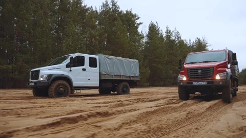 An off-road truck is driving on the sand Stock Footage 320321853