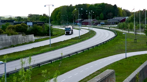 Road twists to the left - traffic on an evening on a spring day Stock Footage 130667553