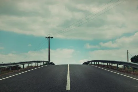 A road under blue sky with clouds, Portugal Stock Photos