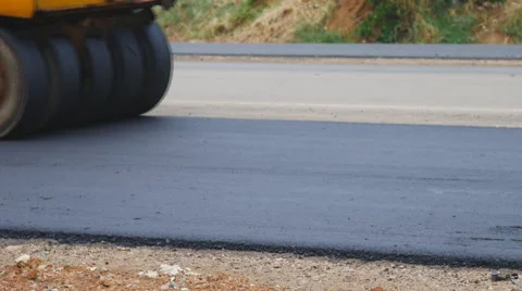 Road under construction, pneumatic tyred roller paver at asphalt road Stock Footage 63260030