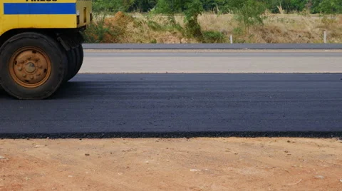 Road under construction, pneumatic tyred roller paver at asphalt road Stock Footage 63270974