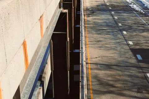 Road under construction with view of empty lane and shadows from nearby str.. Stock Photos