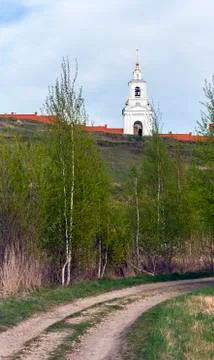 The road under the hill leads to the monastery walls and the bell tower Stock Photos