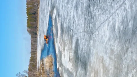 Off-road vehicle in dynamic action, jumping off an ice floe over a water barrier Stock Footage 263079227