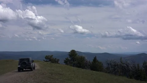 Off Road Vehicle Goes Through Mud Puddle at the Top of a Mountain Stock Footage 201565013