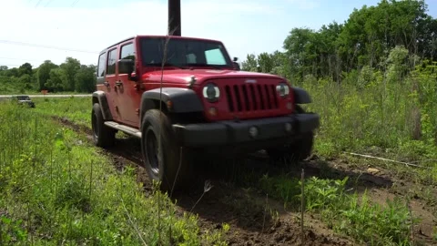 Off road vehicle going up muddy hill Stock Footage 248477301
