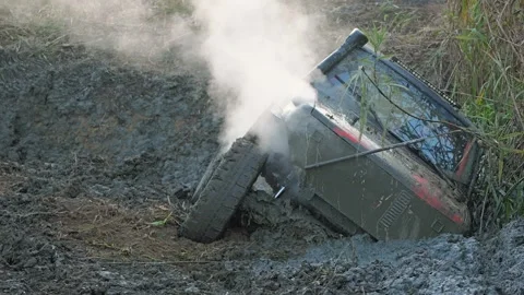 An off-road vehicle got stuck sideways in a deep mud hole during an Stock Footage 344876520
