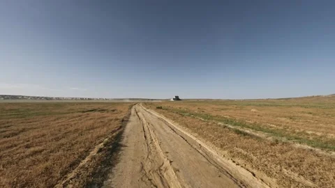 Off-road vehicle navigating dirt path through open landscape at high speed Stock Footage 341790882